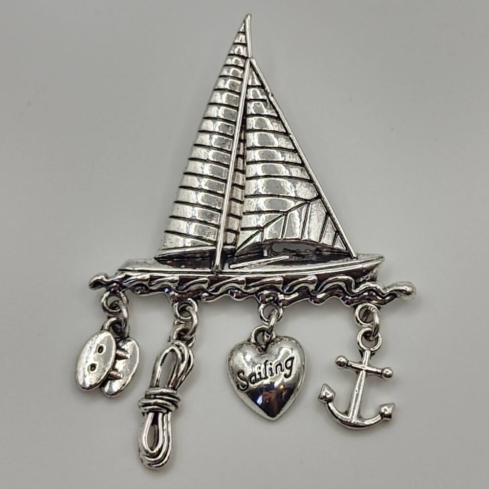 Silver Tone Metal Sailboat Brooch With Dangling Nautical Charms